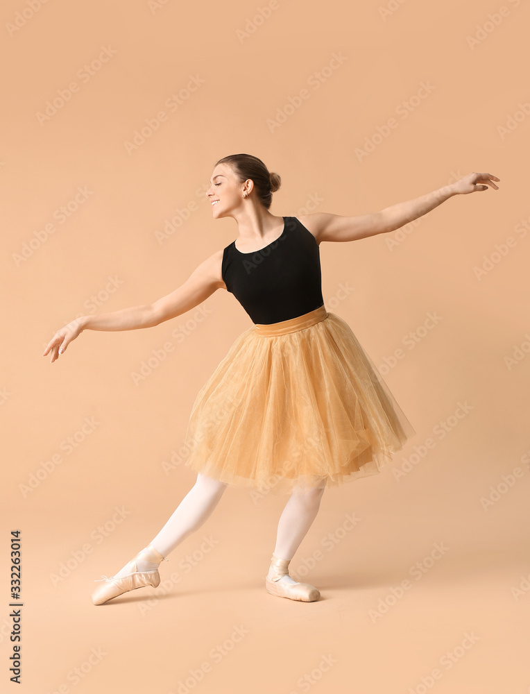 Beautiful young ballerina on color background