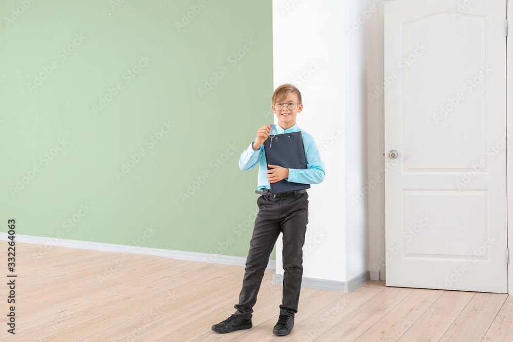 Little real estate agent with key indoors