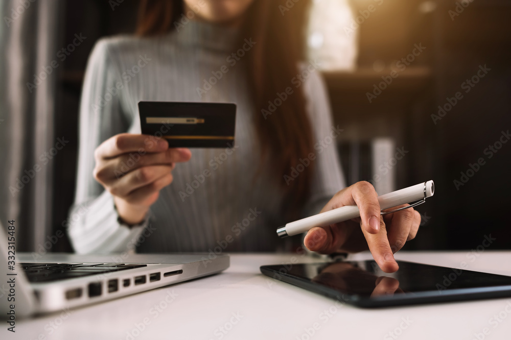 businesswoman hand using smart phone, tablet payments and holding credit card online shopping, omni 