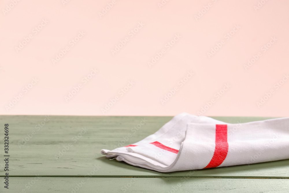 Napkin on table against color background