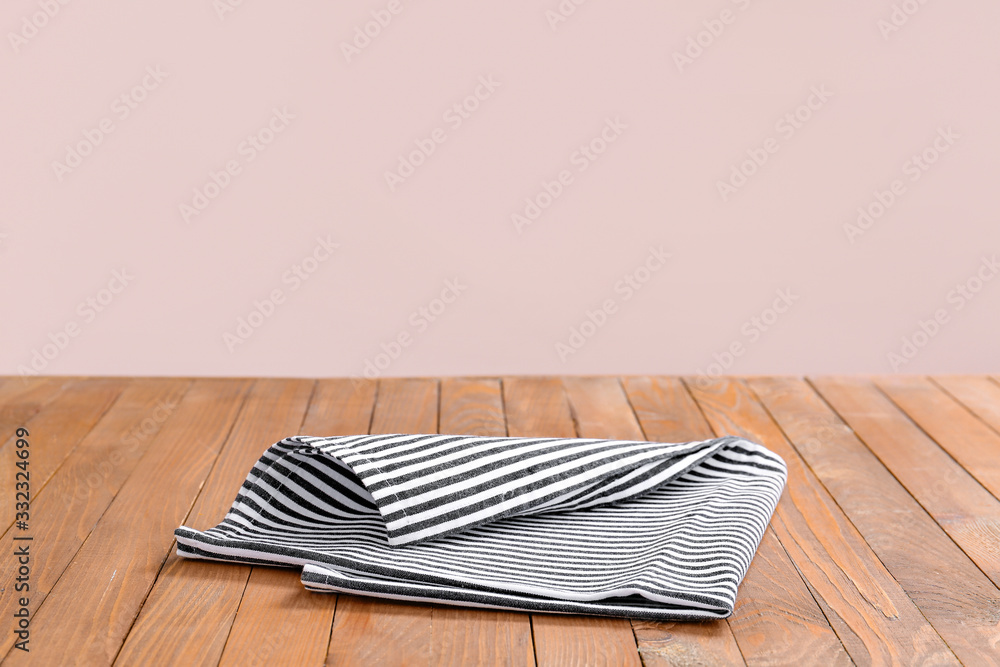 Napkin on table against color background