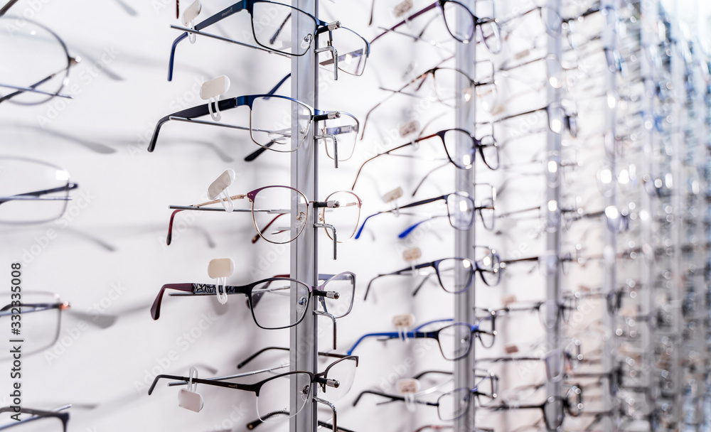 Row of glasses at an opticians. Eyeglasses shop. Stand with glasses in the store of optics. Showcase