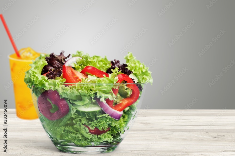 Fresh tasty vegetable salad in bowl on background