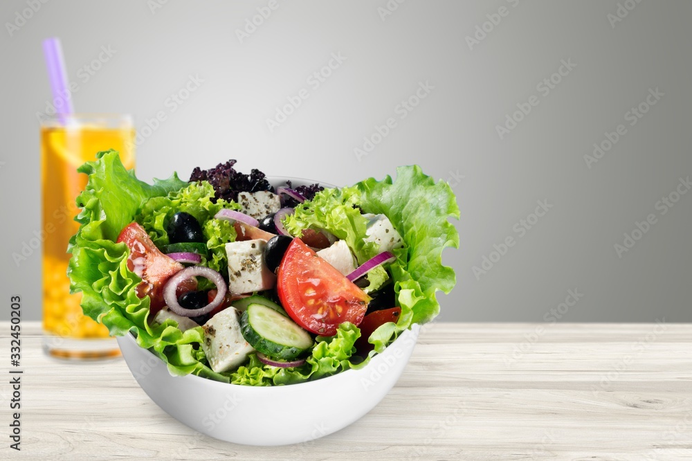 Fresh tasty vegetable salad in bowl on background