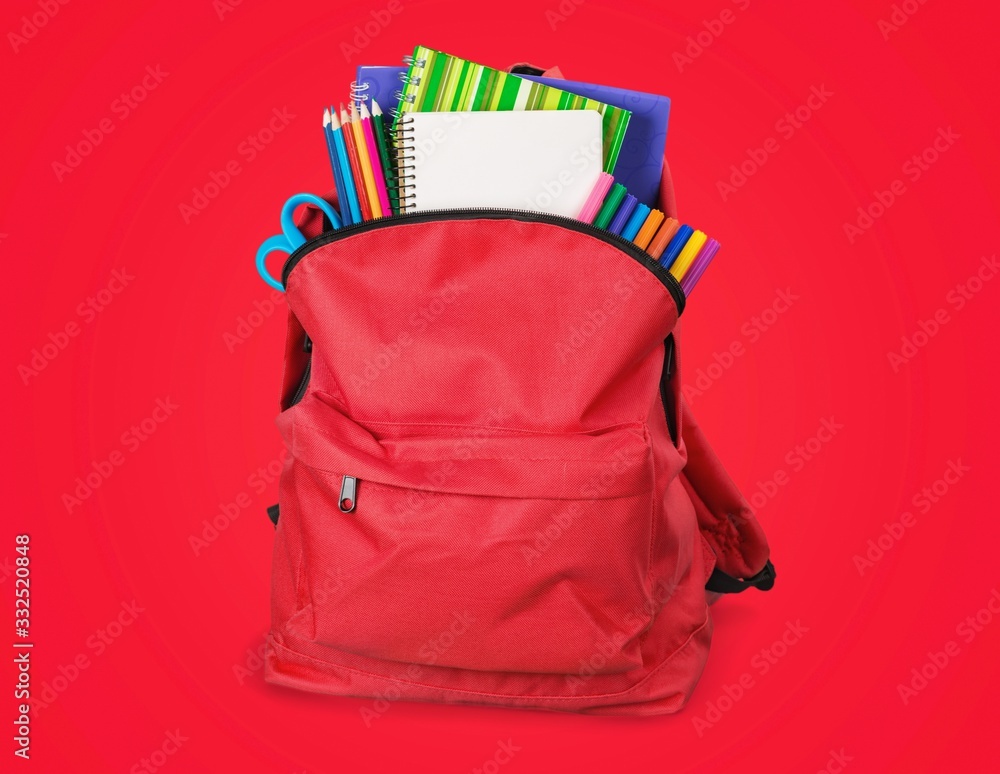 Modern schoolbag with various supplies for education