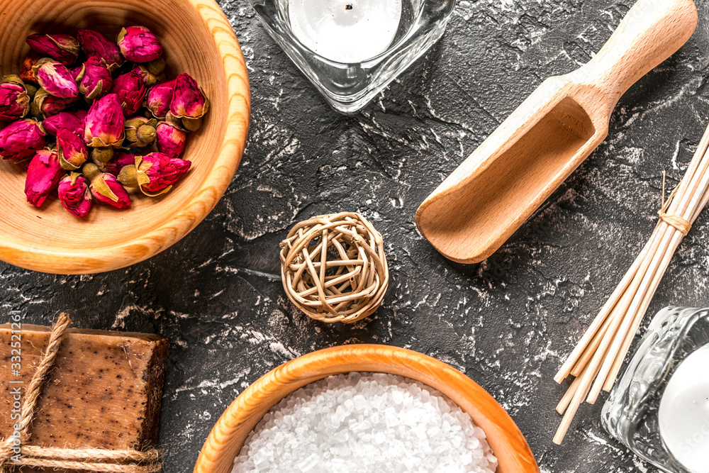 bathroom salt and natural soap for spa on dark background top view