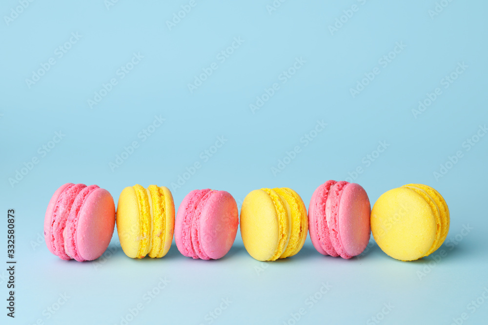 Tasty macarons on color background