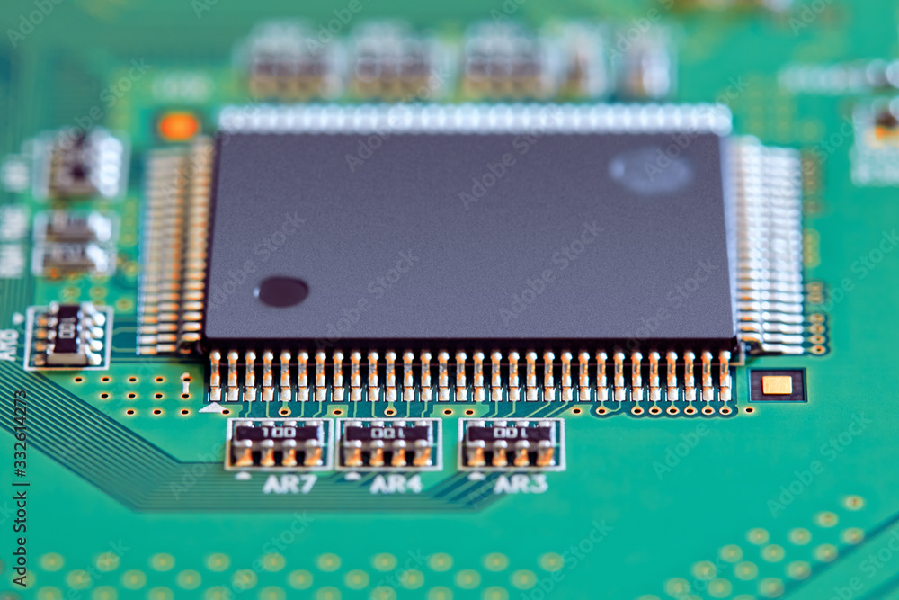 Electronic circuit board with electronic components such as chips close up. Blurry background.	