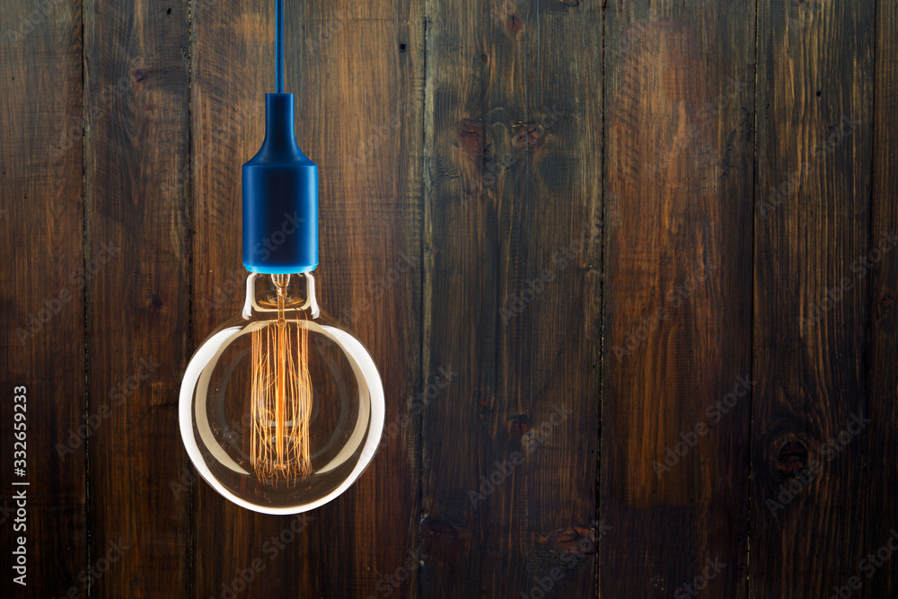 Idea and leadership concept - bulbs on the wooden background