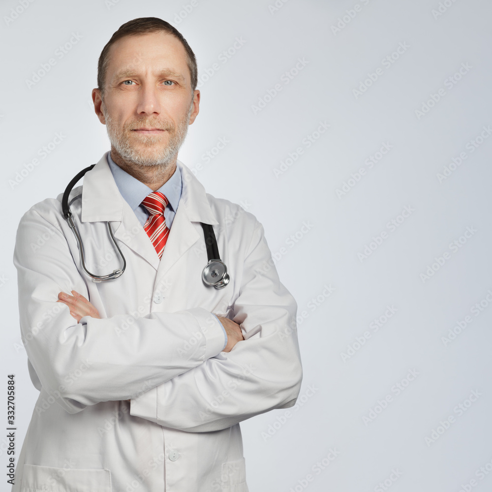 Bearded medical doctor with arms crossed portrait on white background