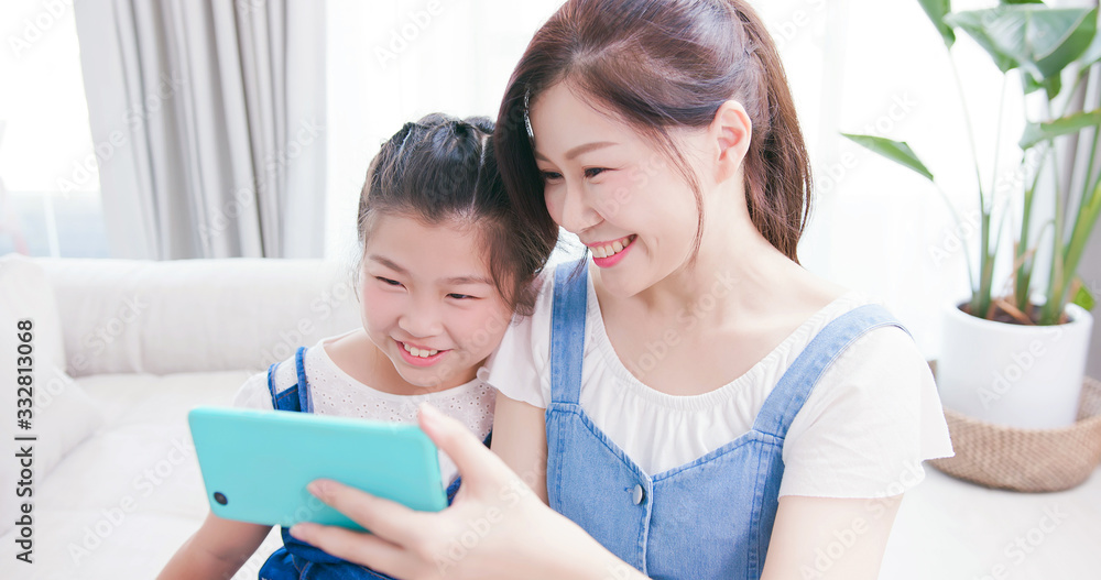 Daughter and mom use smartphone