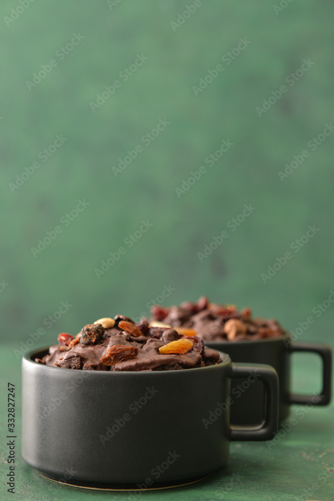 Chocolate mug cakes on color background