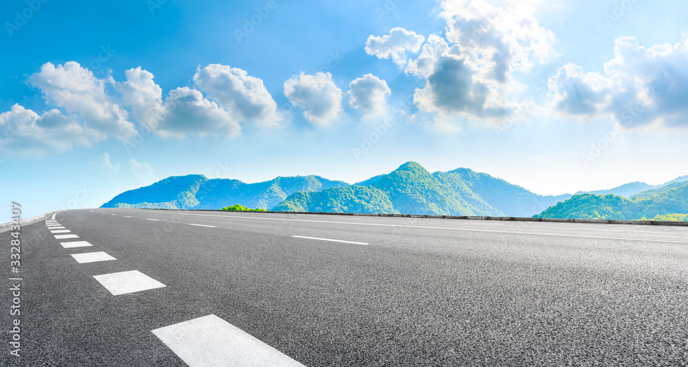 Asphalt road and green mountain nature landscape on sunny day,panoramic view.