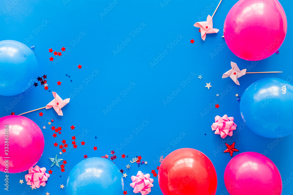 Party concept. Colorful balloons and confetti on blue background top-down frame copy space