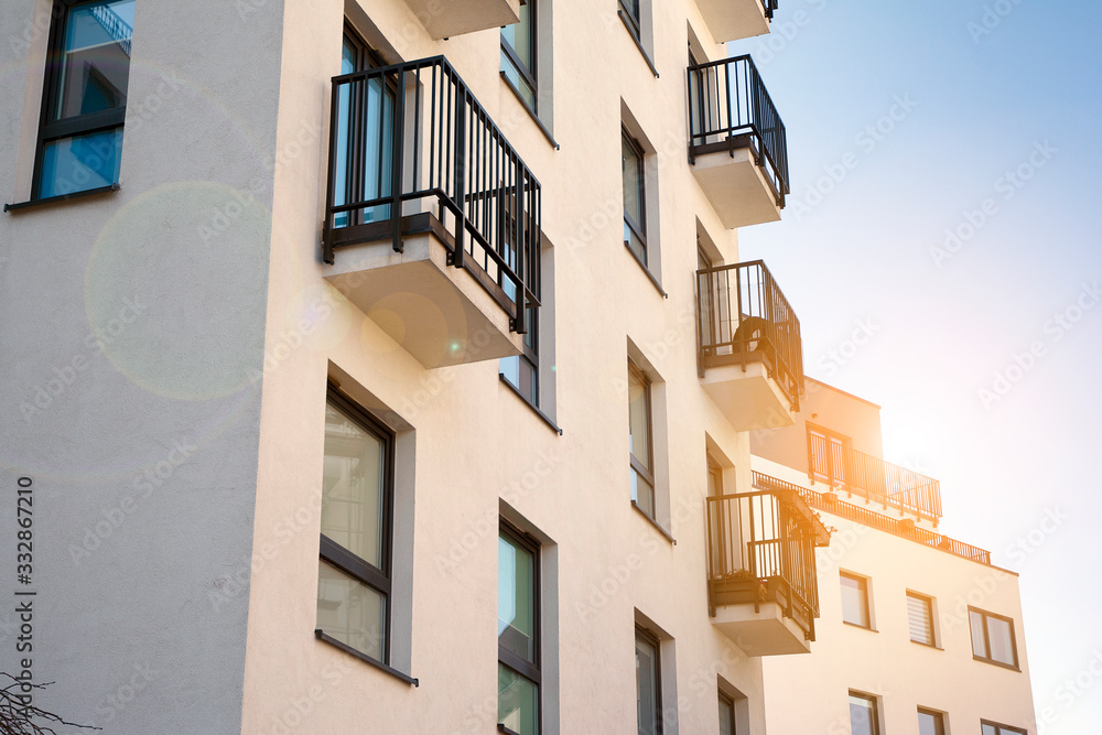 Modern apartment building flat estate concept. Outdoor residential facility at sunset and sunrise.