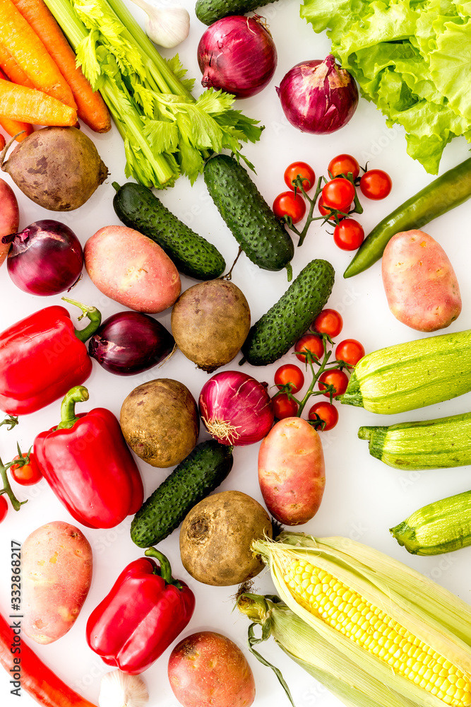 Fresh vegetables still life. Potato, cucumber, beet carrot, greenery on white background top-down