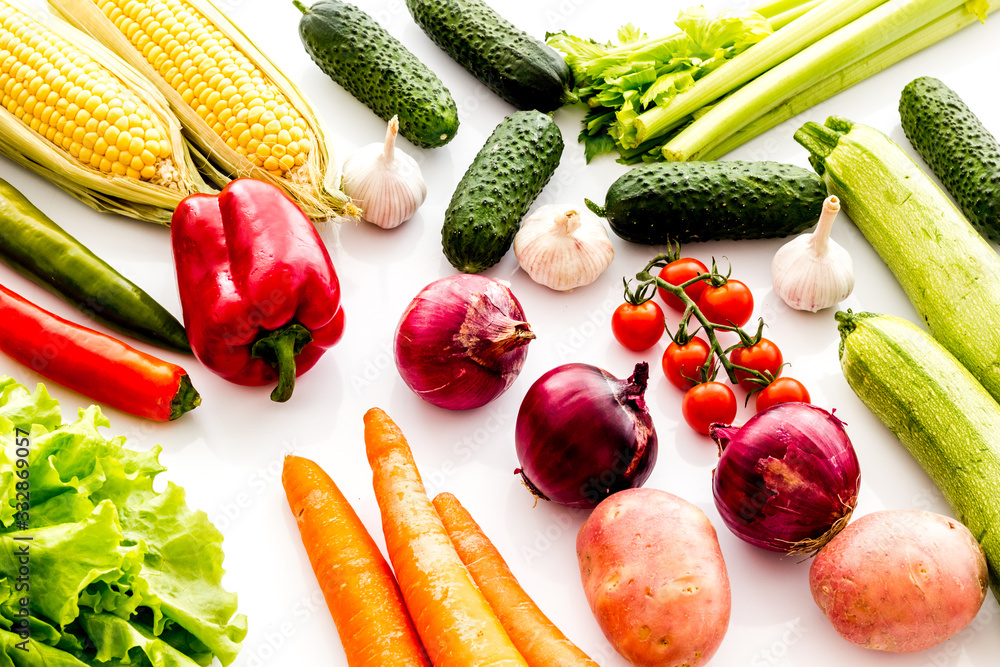 Fresh vegetables still life. Potato, cucumber, beet carrot, greenery on white background