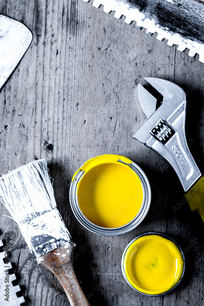 builder work with professional repairing implements set on wooden background top view