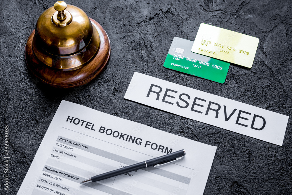 booking hotel room application form and ring dark desk background