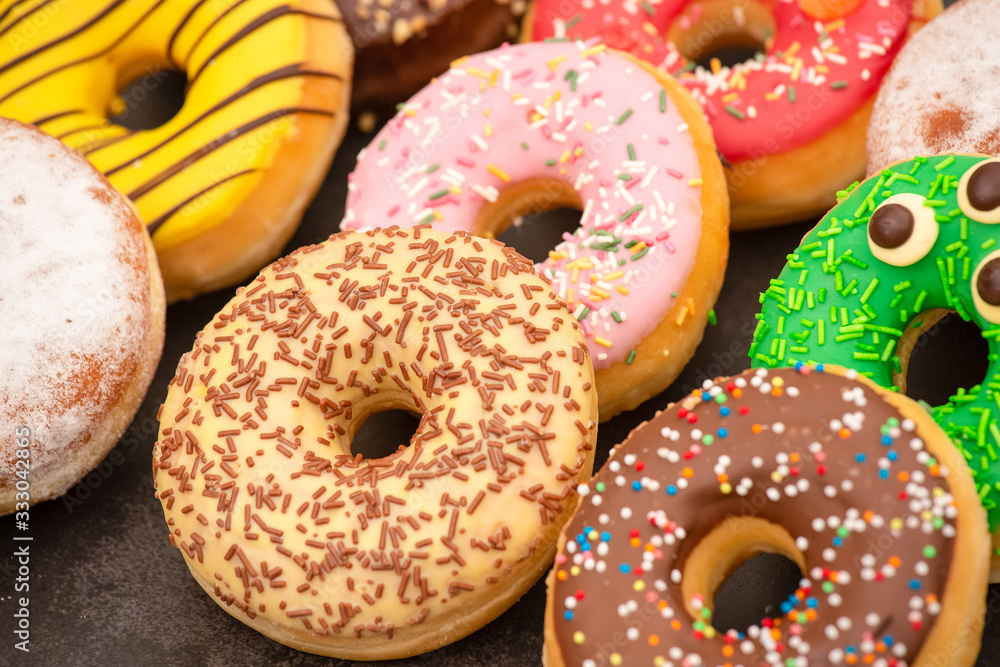 Dessert, Donuts, chocolate and strawberry circles, sugar and cream on Donuts and hot coffee cups, pr