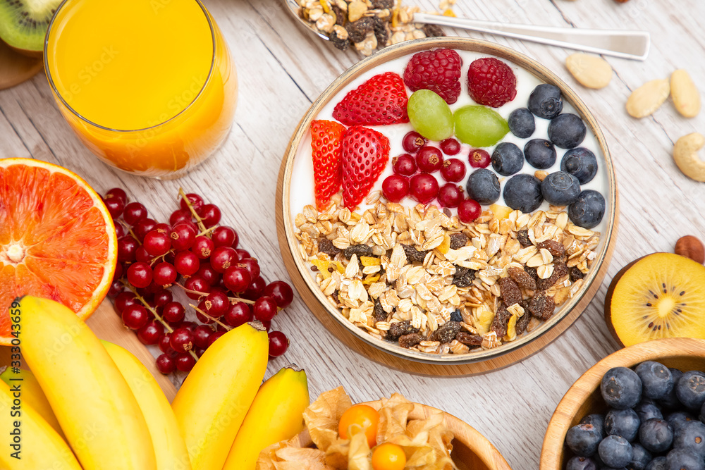 Group Fruits Breakfast mixed vegetables with salad bowl, nuts bowl, strawberry, banana, and pineappl