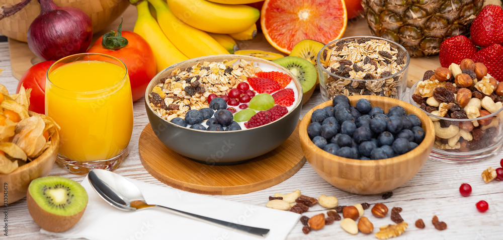 Group Fruits Breakfast mixed vegetables with salad bowl, nuts bowl, strawberry, banana, and pineappl