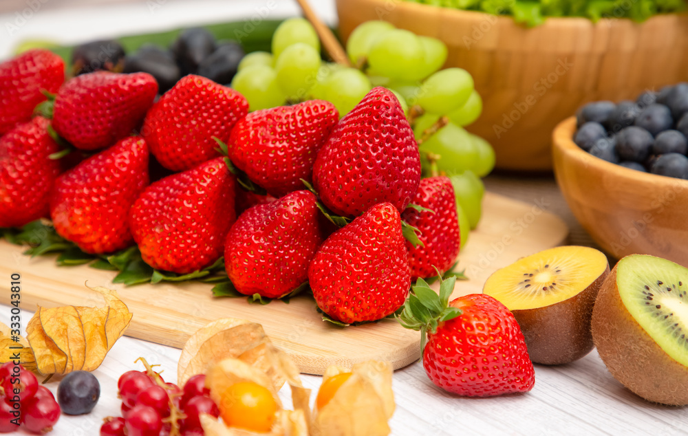 Group Fruits Breakfast mixed vegetables with salad bowl, nuts bowl, strawberry, banana, and pineappl