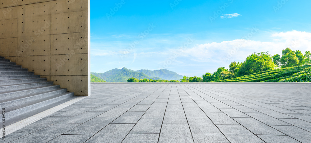 Empty square floor and green tea mountain nature landscape on sunny day,panoramic view.