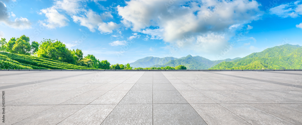 Empty square floor and green tea mountain nature landscape on sunny day,panoramic view.