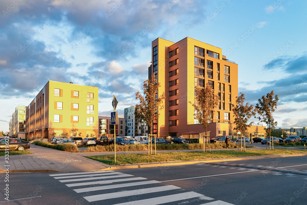 Apartment house home residential building complex street parking sunset