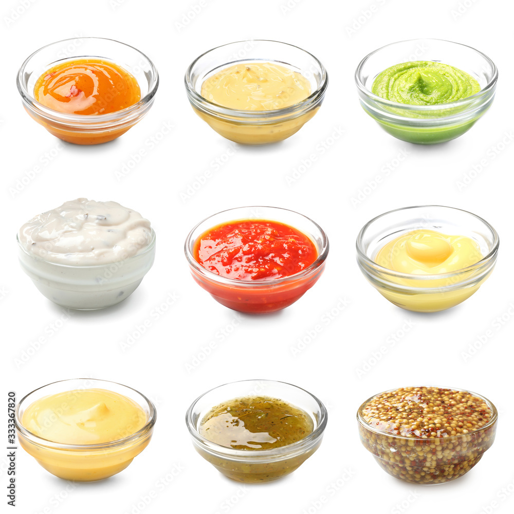 Different tasty sauces in bowls on white background