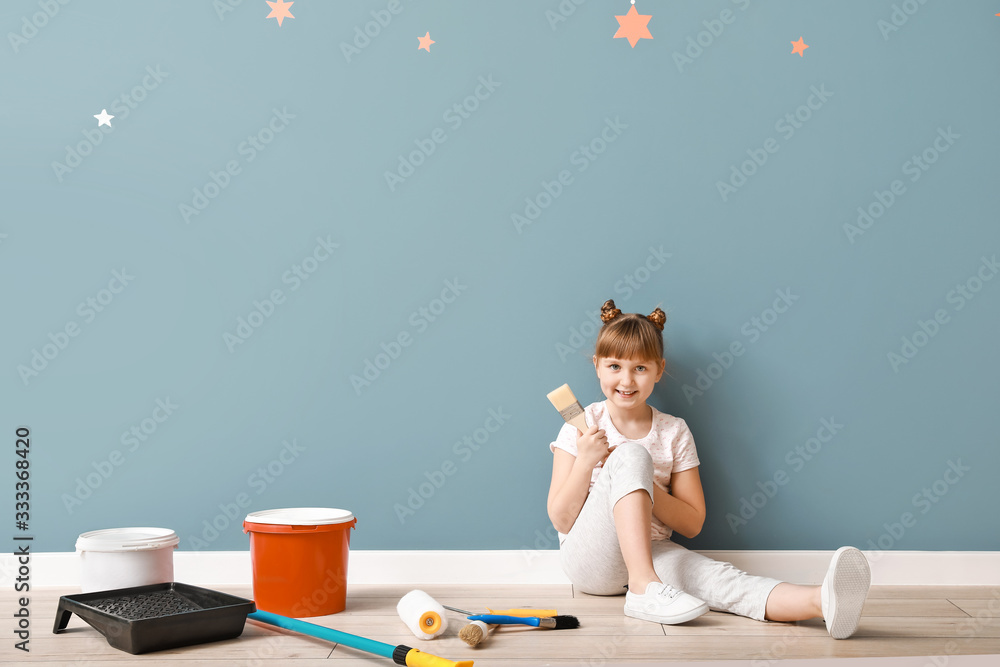 Little girl with painter tools in room