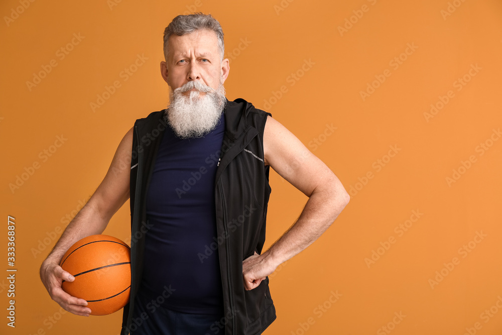 Elderly basketball player on color background