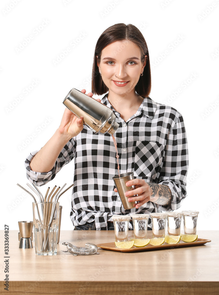 Beautiful female bartender at table against white background