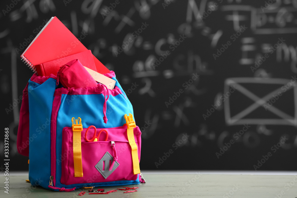 School backpack on table in classroom