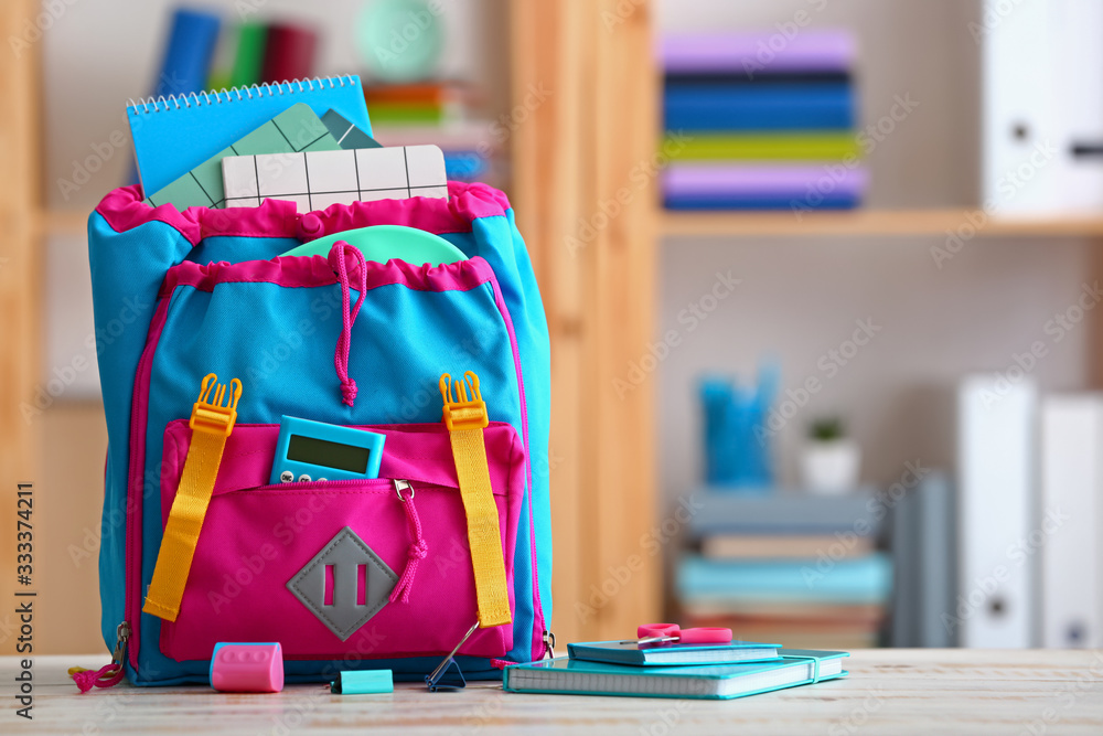 School backpack on table in classroom