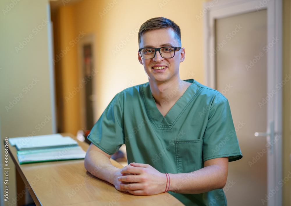 Male doctor near reception desk in clinic