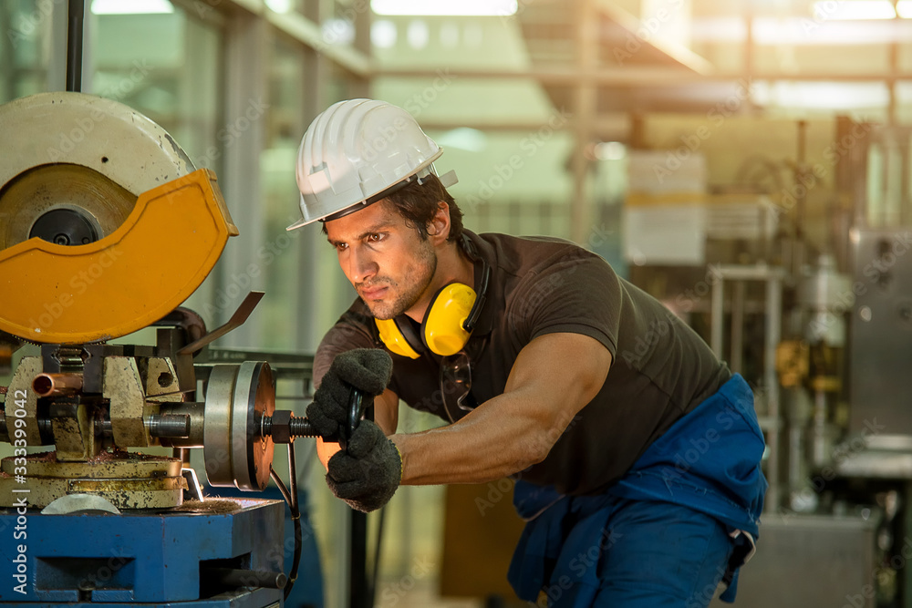 Mechanic wearing uniform safety in factory working machine lathe metal,Industry concept.