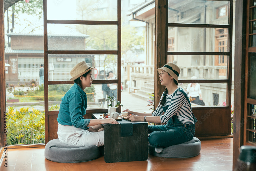 side view of two asian young girl travelers in straw hat travel in Tokyo Japan during spring time. h