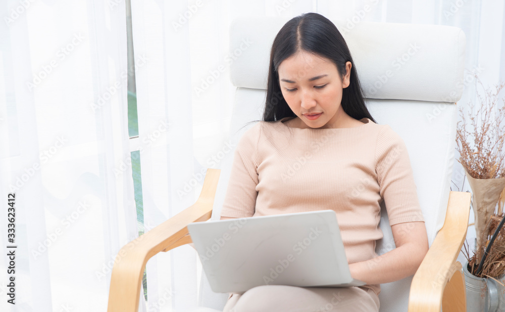 Asian businesswoman working on her laptop  through internet and media technology at home. Happy morn