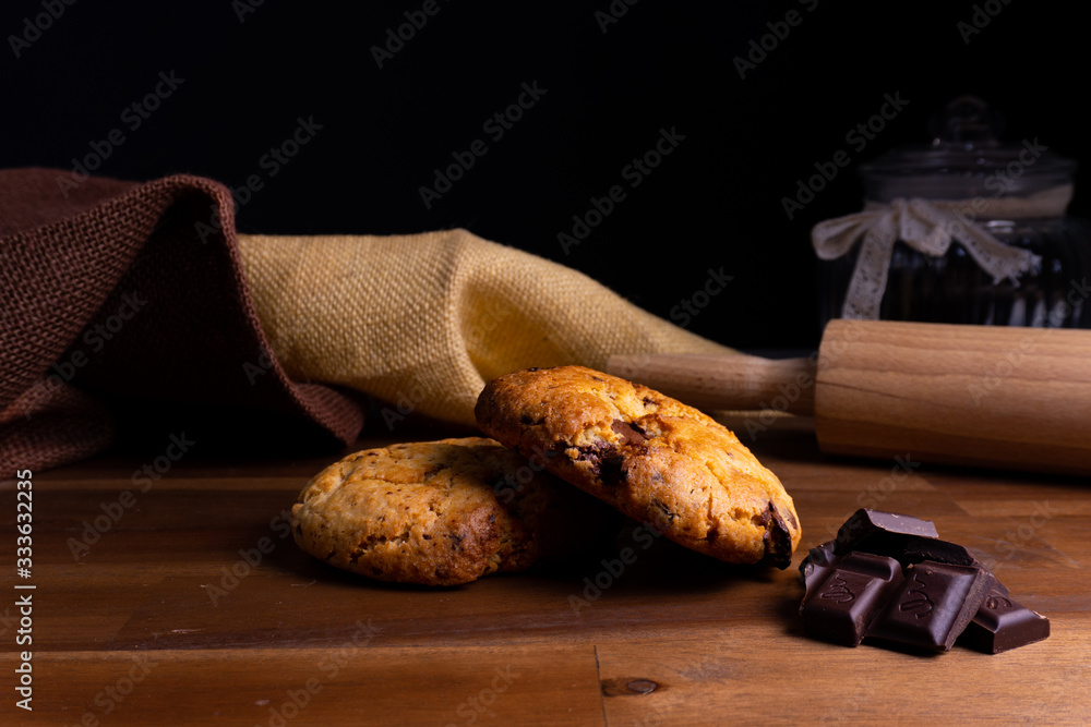 Two delicious cookie cakes with chocolate on a wooden board with copy space