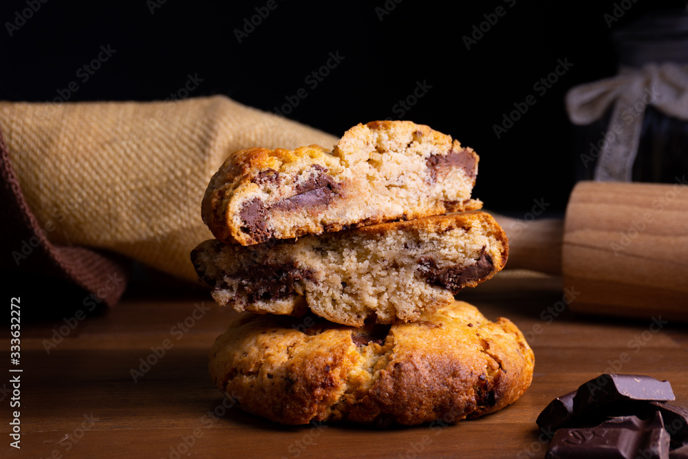 Two delicious cookie cakes with chocolate on a wooden board with copy space