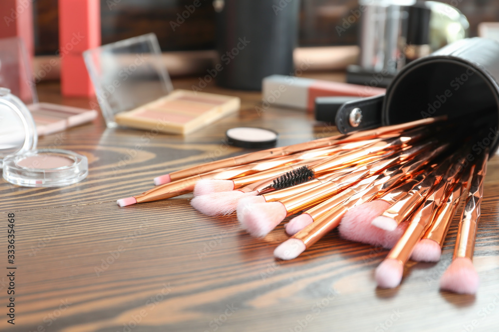 Set of brushes and decorative cosmetics on table of makeup artist