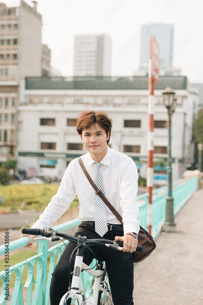 Successful businessman riding bicycle