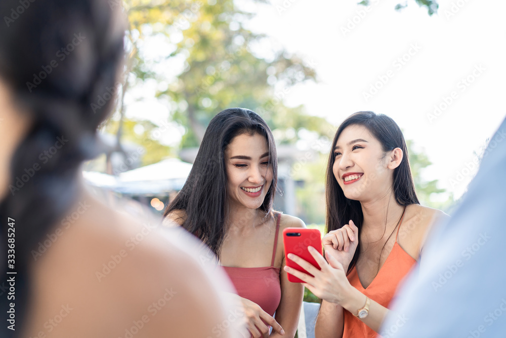 Group of best Asian friends people sitting in outdoor restaurant having meal for lunch together. You