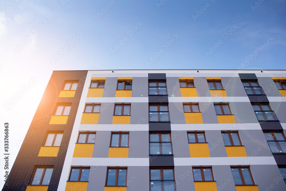 Modern apartment building flat estate concept. Outdoor residential facility at sunset and sunrise.