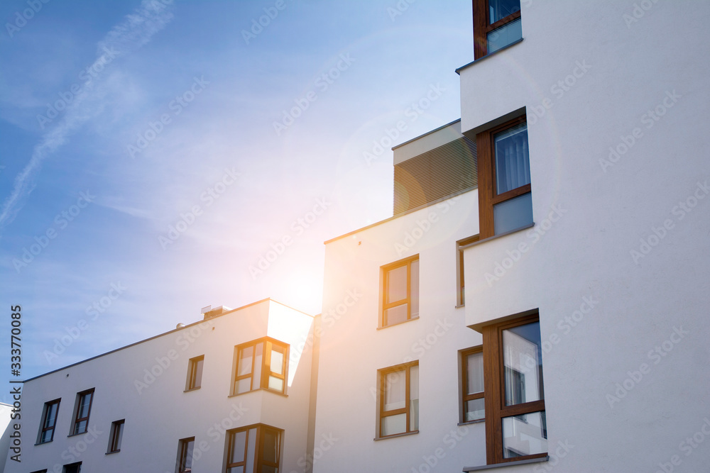 Modern apartment building flat estate concept. Outdoor residential facility at sunset and sunrise.