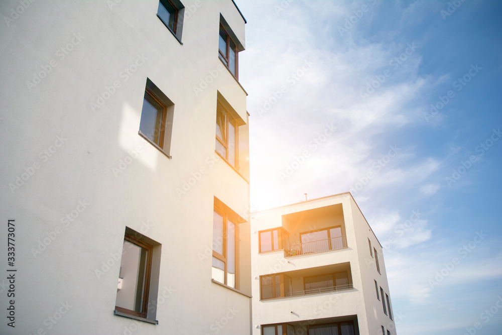 Modern apartment building flat estate concept. Outdoor residential facility at sunset and sunrise.