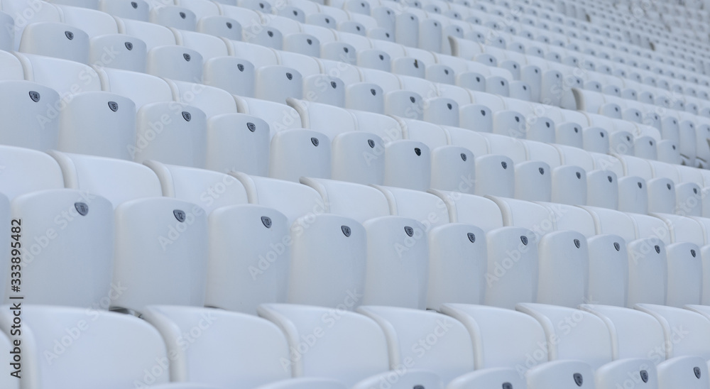 Empty white chairs at the soccer stadium during quarantine