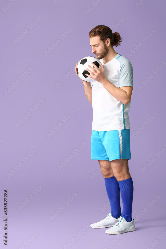 Male football player on color background